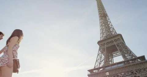 Happy tourist couple looking up at Eiffel Tower sightseeing enjoying European Stock Footage 73338387