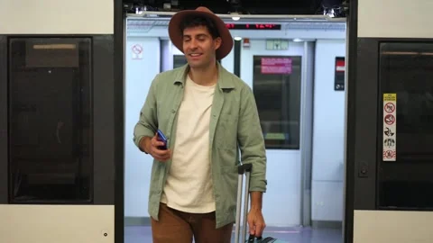 Happy traveler getting off train with suitcase and smartphone at vacation d.. Stock Footage 298562955