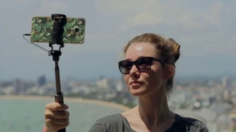 Happy traveler woman is taking photo. Young girl take selfie with phone and Stock Footage