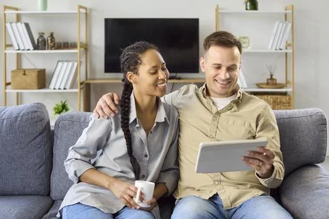 Happy using digital tablet at home, online browsing and planning together 스톡 사진