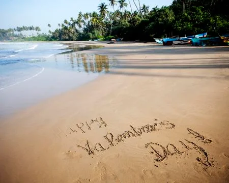 "Happy Valentines day!" written in sand on tropical beach - vintage photo Stock Photos