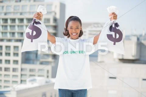 Happy volunteer woman holding money bags Stock-Fotos