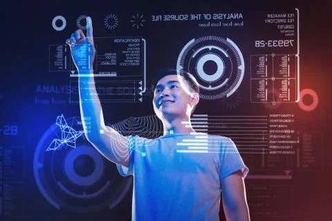 Happy web developer pointing to the icon while working in his futuristic office Foto stock