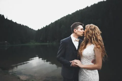 Happy wedding couple posing over beautiful landscape in the mountains Fotos Stock