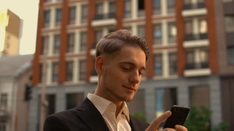 Happy white collar worker use mobile outdoor Stock Footage 90698692
