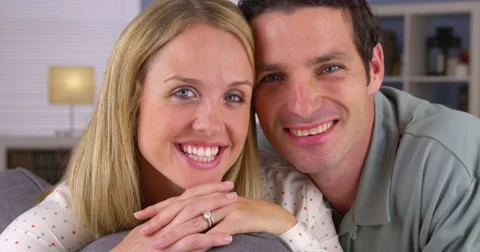 Happy white couple sitting on couch Video stock 44480640