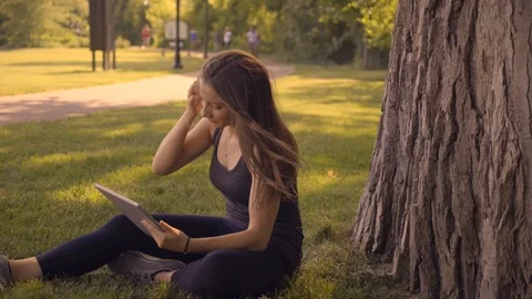 Happy White Female with Tablet Computer in Park 1 Stock Footage 91982306