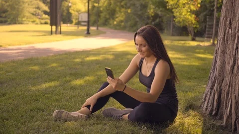 Happy White Female Using Facetime on Phone in Park Stock Footage 91981504