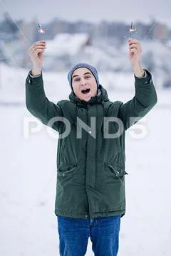 Happy white man in warm winter jacket outdoors enjoys winter journey, winter Stock Photos