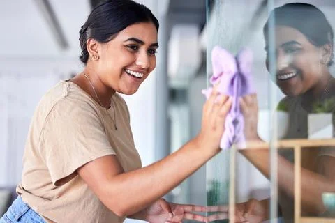 Happy, woman and cleaning home window with household cloth and satisfied smile Stock Photos