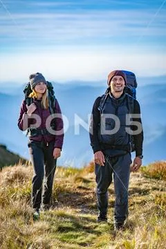 The happy woman and a man walking on the mountain Stock Photos