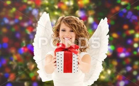 Happy woman with angel wings and christmas gift Stock Photos