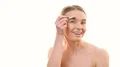 The happy woman applying makeup on her face on the white background 4k or 4k+ Resolution