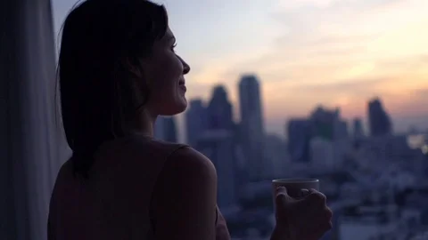 Happy woman with beverage admire view from window, super slow motion 240fps Stock Footage