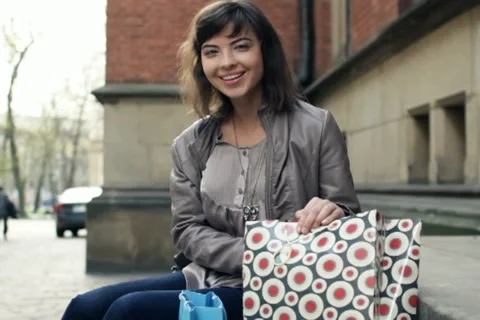 Happy woman checking her shopping bags in the city, steadicam shot NTSC Stock Footage