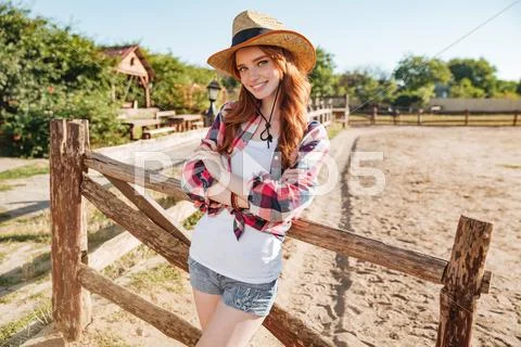 Happy woman cowgirl standing with hands folded Stock Photos