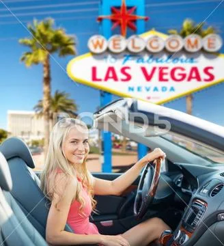 Happy woman driving convertible car at las vegas Stock Photos