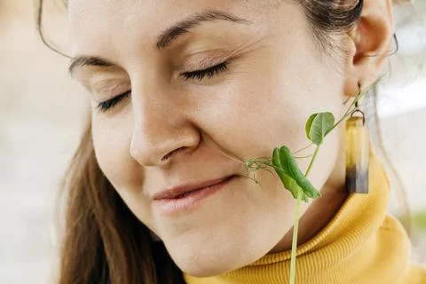 Happy woman eating freshly cut sprout of microgreen superfood Stock Photos