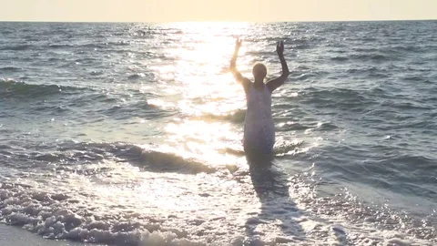 Happy woman enjoying a beautiful sunrise/sunset on the sea. Stock Footage