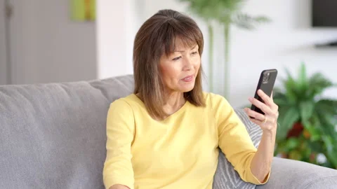 Happy woman enjoying smartphone video Stock Video Pond5