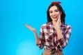 The happy woman gesturing on the blue background Photo