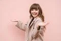 The happy woman gesturing on the pink wall background Photo