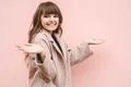The happy woman gesturing on the pink wall background Photo