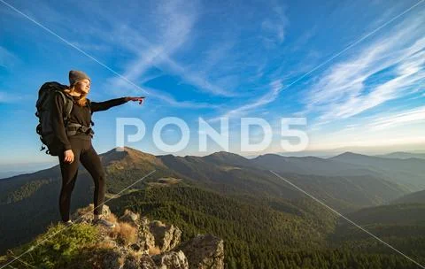 The happy woman gesturing on the sunny mountain Stock Photos