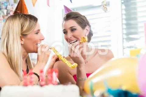 Happy woman having fun while celebrating her birthday with her best friend Stock Photos