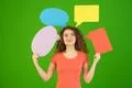 The happy woman hold a dialog signs on the green background Photo