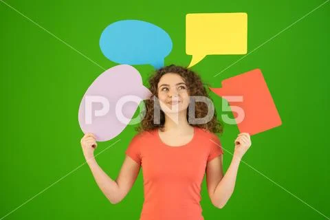 The happy woman hold a dialog signs on the green background Stock Photos