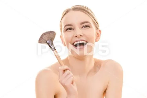 The happy woman holding a cosmetic brush on the white background Stock Photos