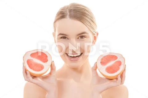 The happy woman holding a grapefruit on the white background Stock Photos