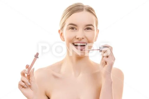 The happy woman holding a lip gloss on the white background Stock Photos