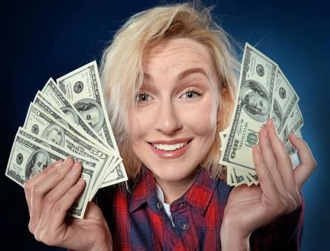 Happy woman holding a lot of dollar money Stock Photos