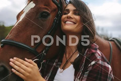 Happy woman hugging her horse Stock Photos