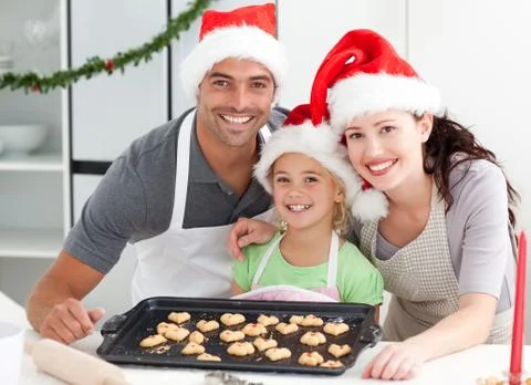 Happy woman with husband and daughter ith their biscuits ready Stock Photos