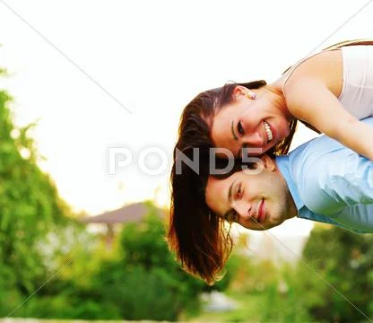 Happy Woman Jumped On Man's Back