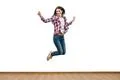 The happy woman jumping on the white wall background Photo