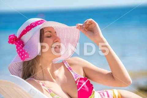 The happy woman lay on the background the sea Stock Photos