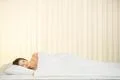 The happy woman lay on the bed Photo