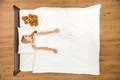 The happy woman lay on the bed with the soft toy. View from above Photo