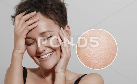 Happy woman with a lens showing her ideal skin Stock Photos