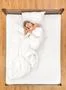 The happy woman lie on the bed. View from above Photo