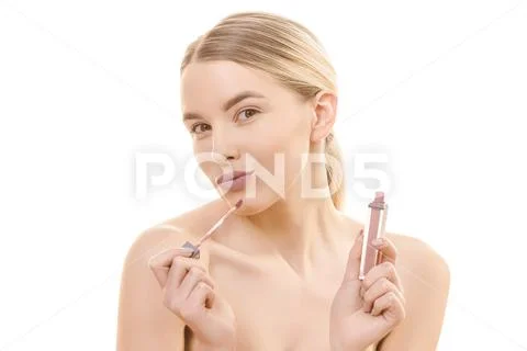 The happy woman with a lip gloss on the white background Stock Photos