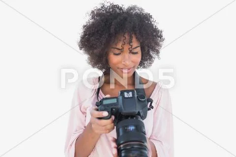 Happy woman looking at digital camera Stock Photos
