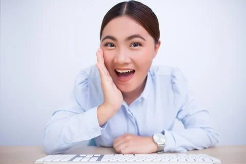 Happy woman make the gossip gesture at office Stock Photos