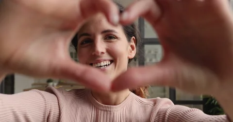 Happy woman makes with fingers heart shape gives you love Stock Footage