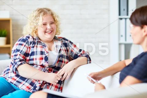 Happy woman with overweight looking at psychologist Stock Photos