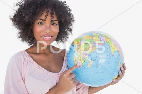 Happy woman pointing to globe Stock Photos